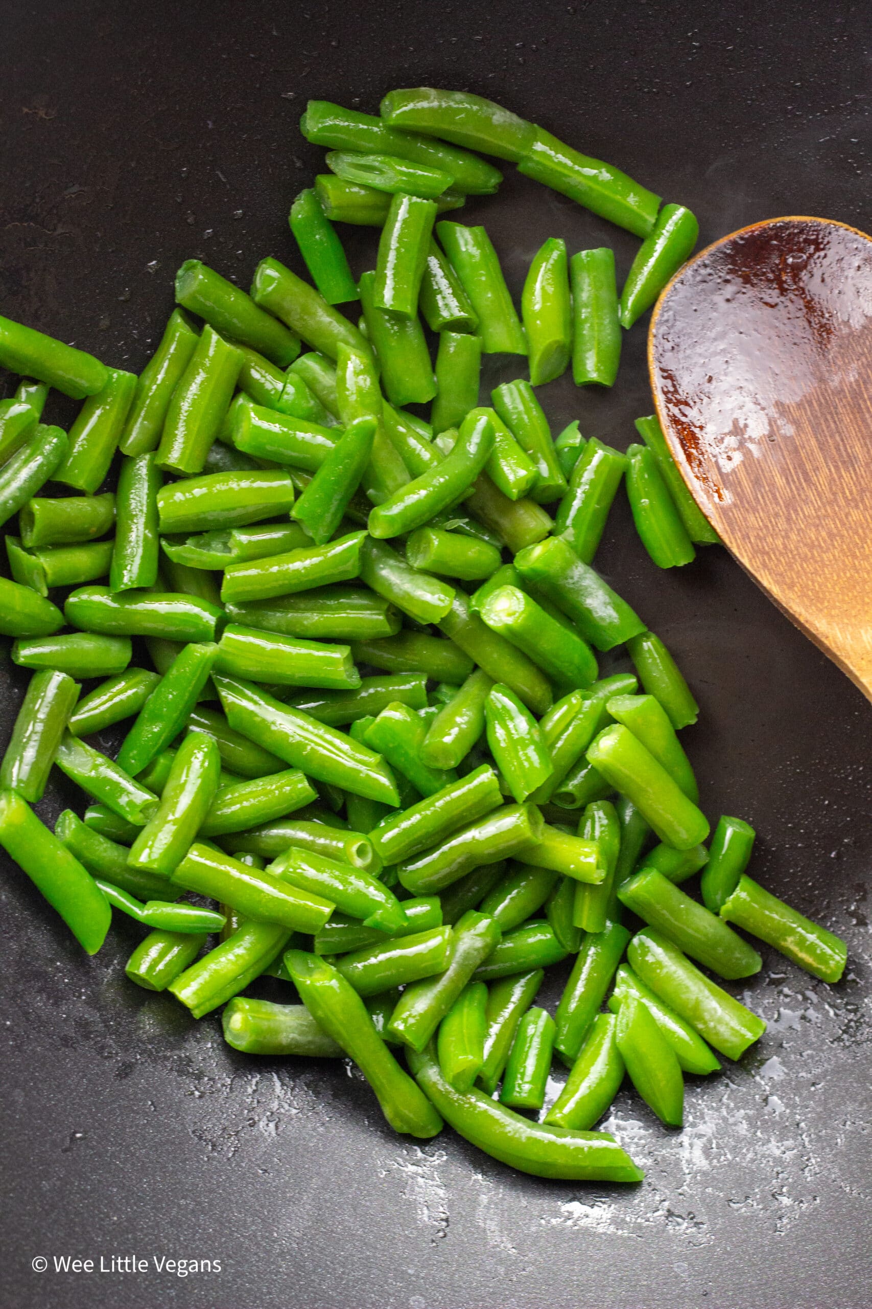Cooked green beans in a wok.