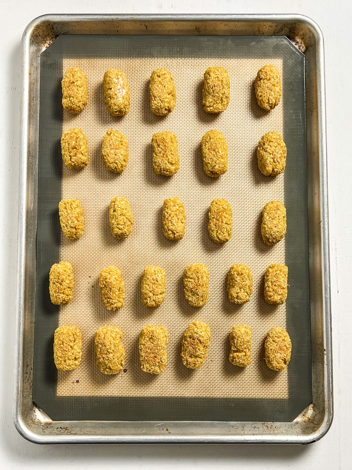 Overhead shot of tots on a baking sheet after being baked.