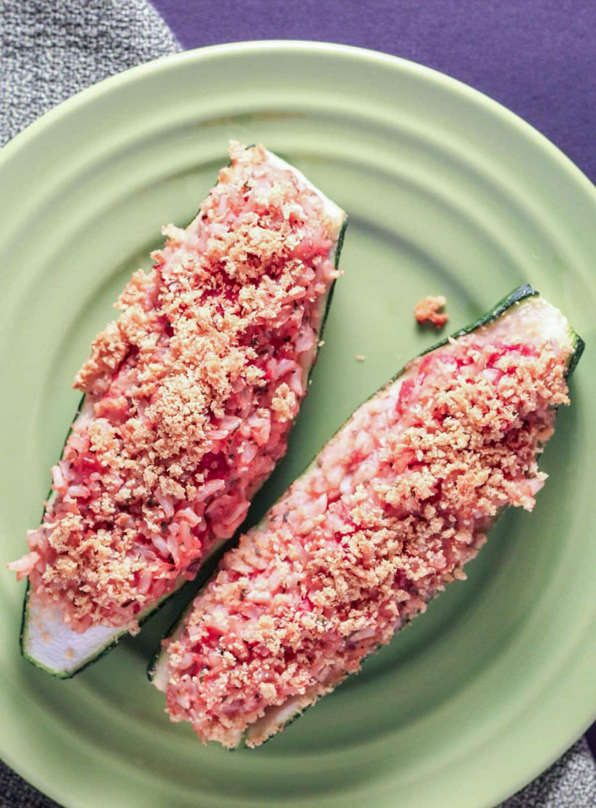 Overhead shot of Vegan Stuffed Zucchini on a small green plate.