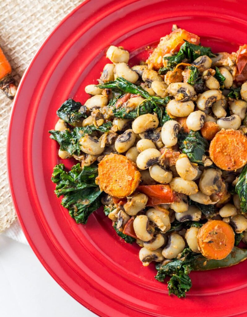 Overhead close up shot of Black Eye Pea Hash on a small red plate.