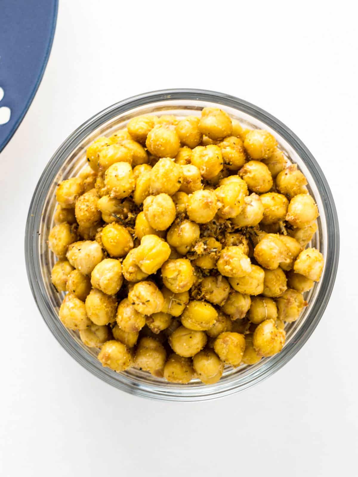 Overhead view of a small bowl of Cheezy Herb Roasted Chickpeas.