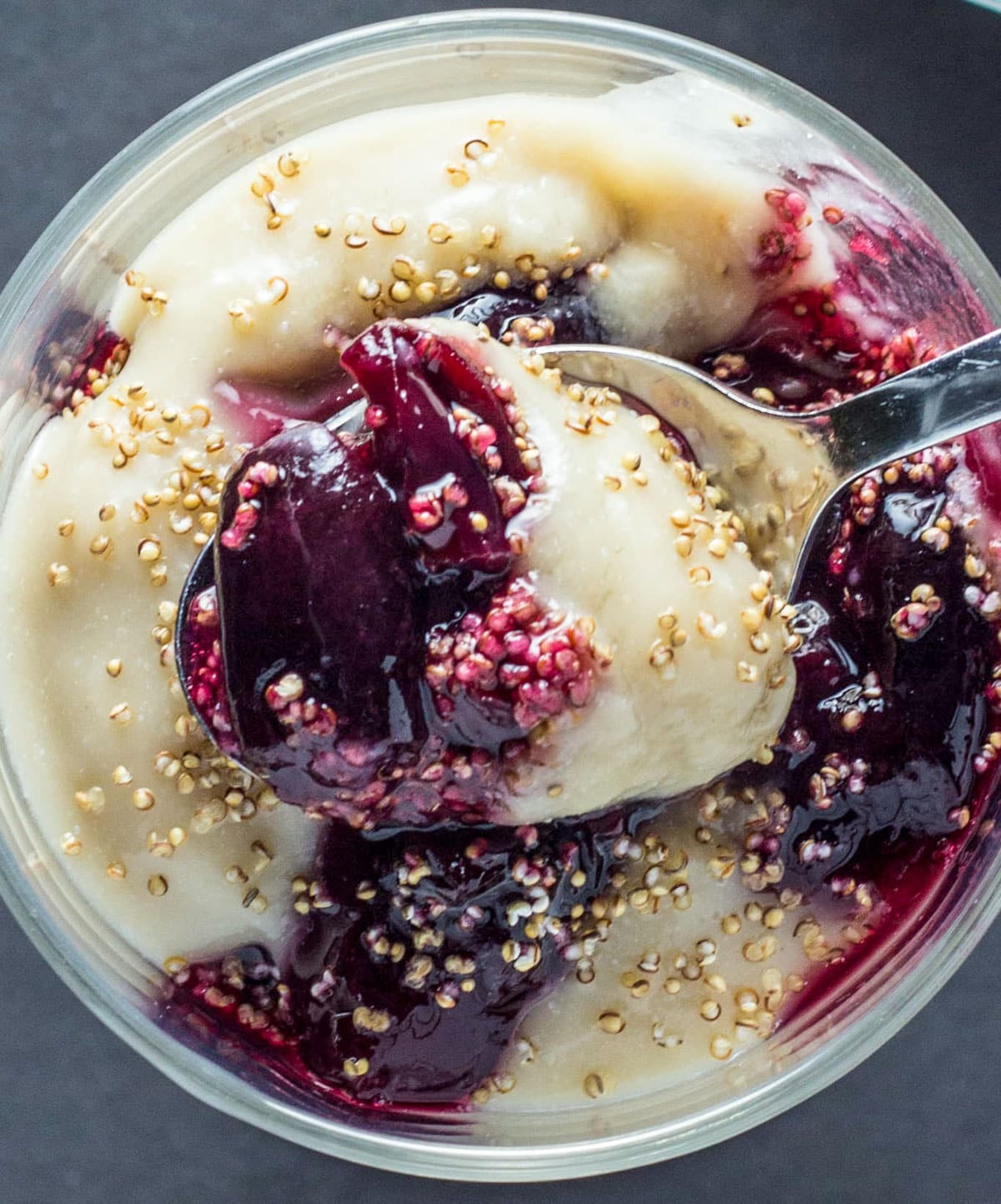 Close up top view of Cherry Maple-Vanilla Pudding Parfait with a spoon.