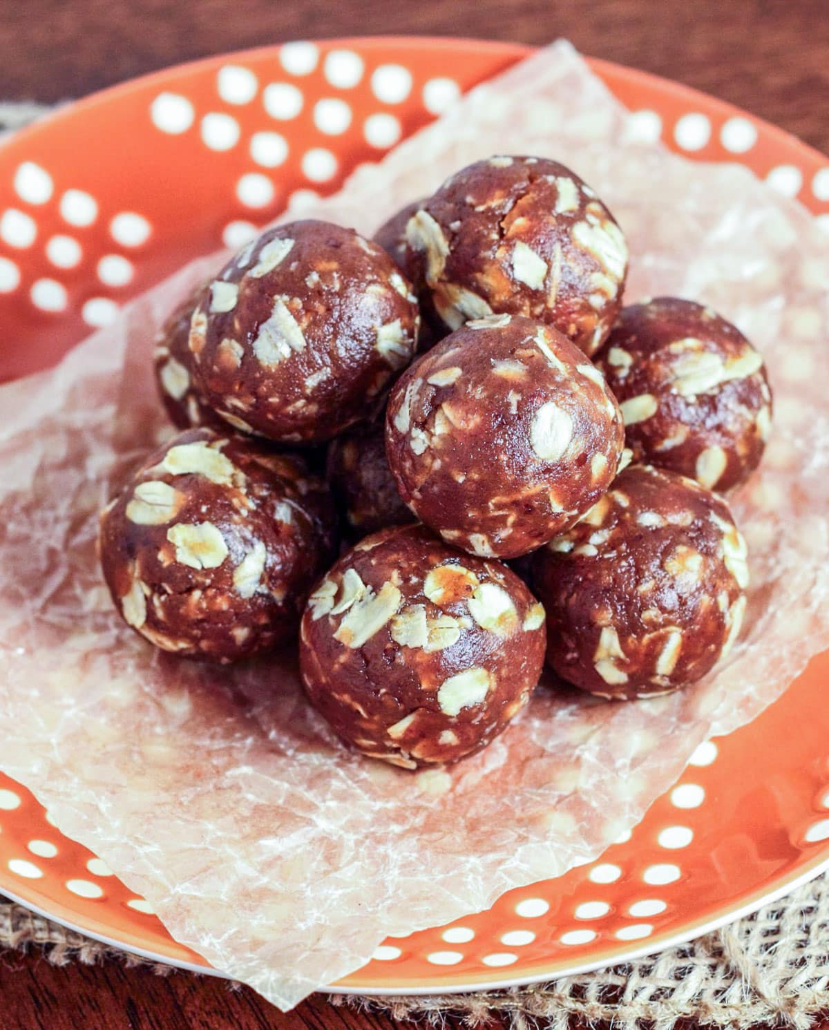 No Bake Peanut Butter Oatmeal Balls Stacked on an orange plate.