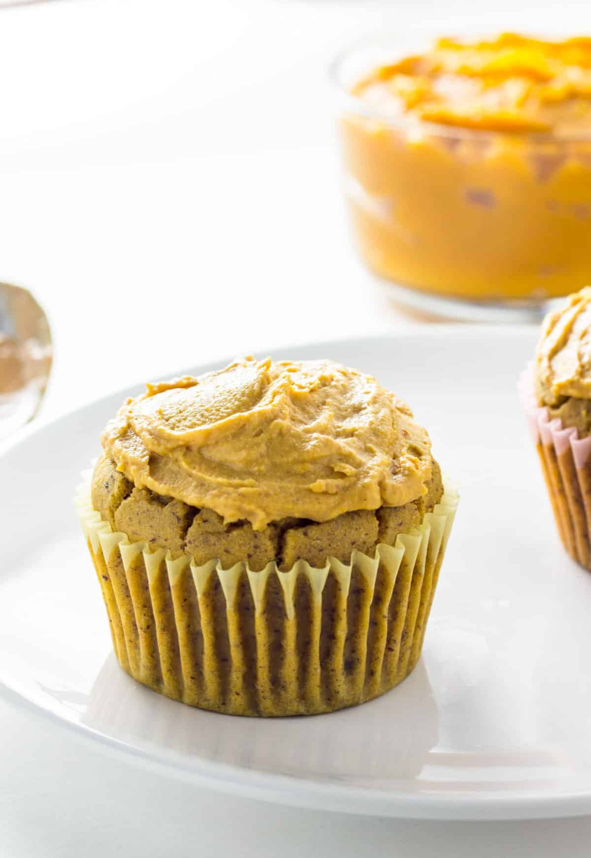 Frosted Peanut Butter Pumpkin Pupcakes on a small plate.