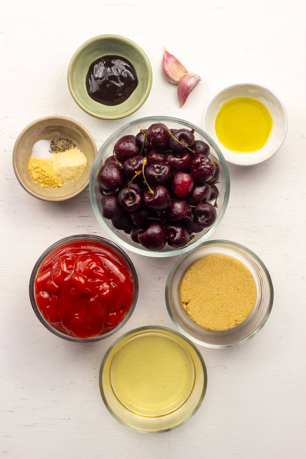 The ingredients to make Cherry Barbecue Sauce. There are cherries, ketchup, brown sugar, apple cider vinegar, oil, spices, garlic and hoisin.
