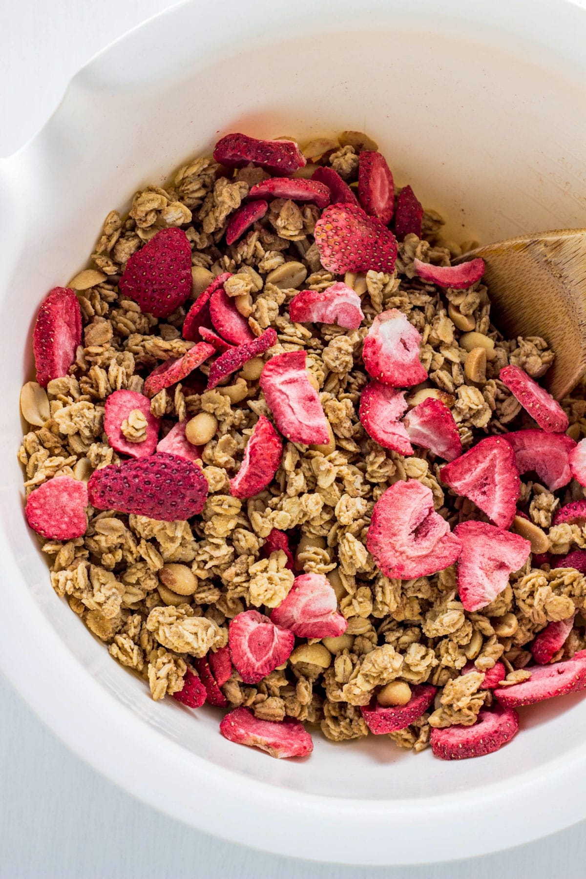 Close up of Peanut Butter & Jelly Granola in a large white bowl.