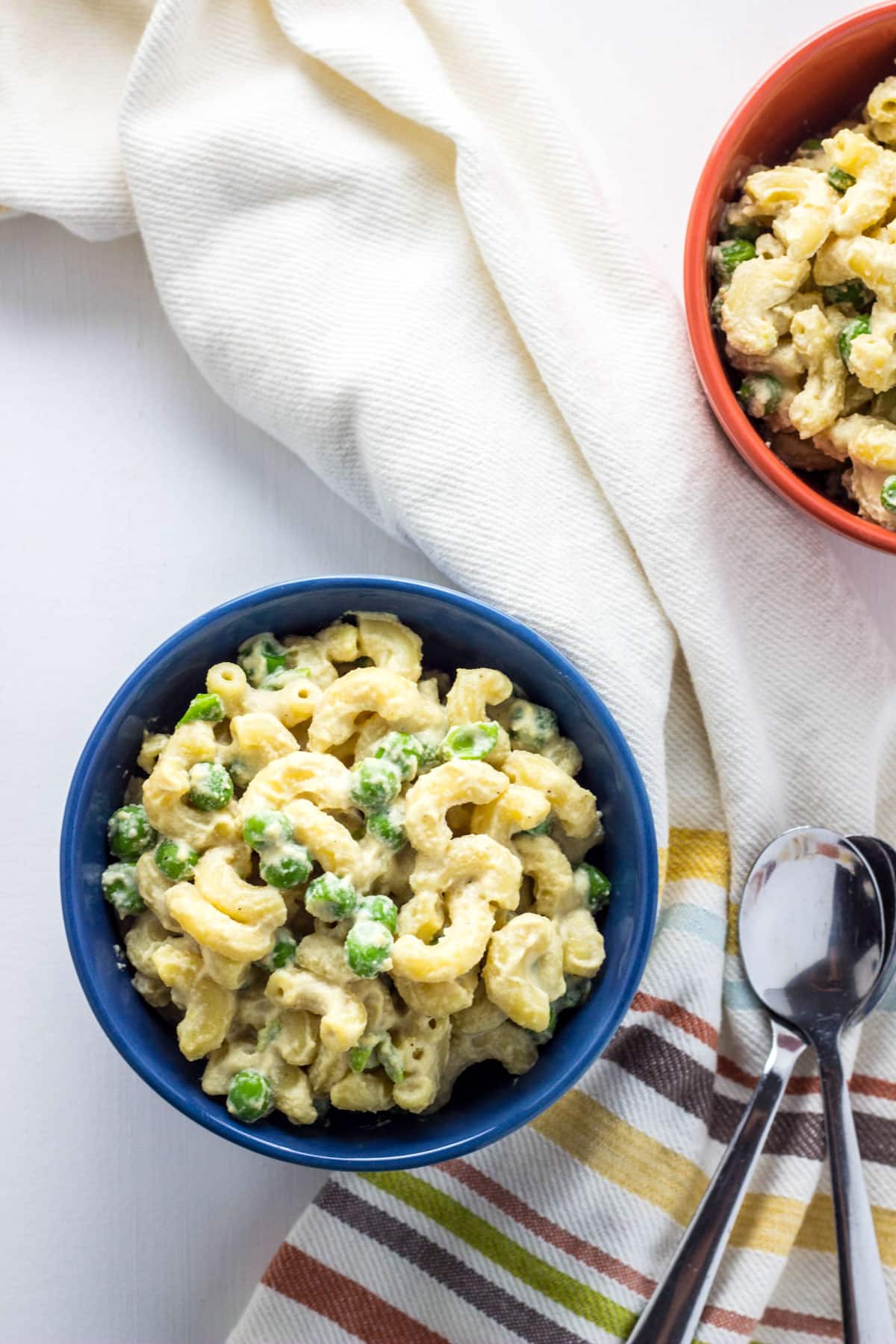 Overhead view of a bowl of Vegan Cashew Mac 'n Cheese with Peas.