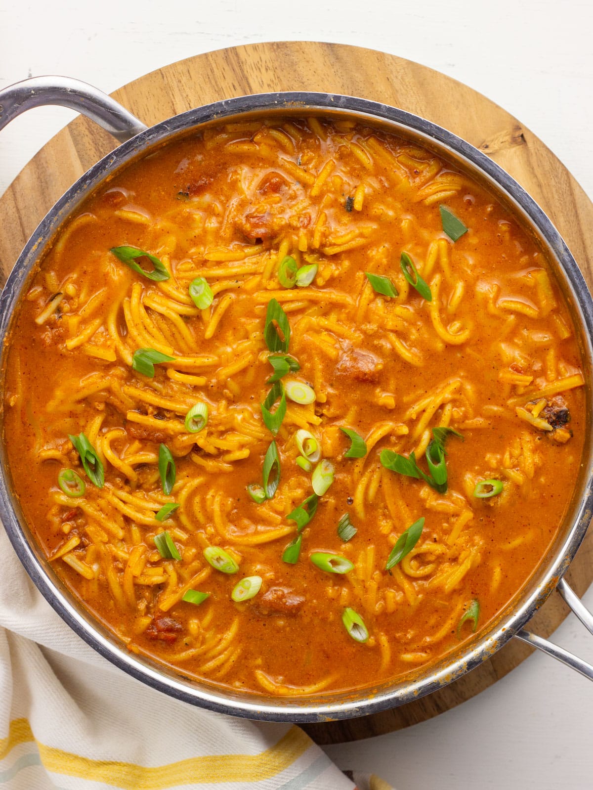 Overhead view of a pan of Vegan Taco Spaghetti. There are green onions over the top.