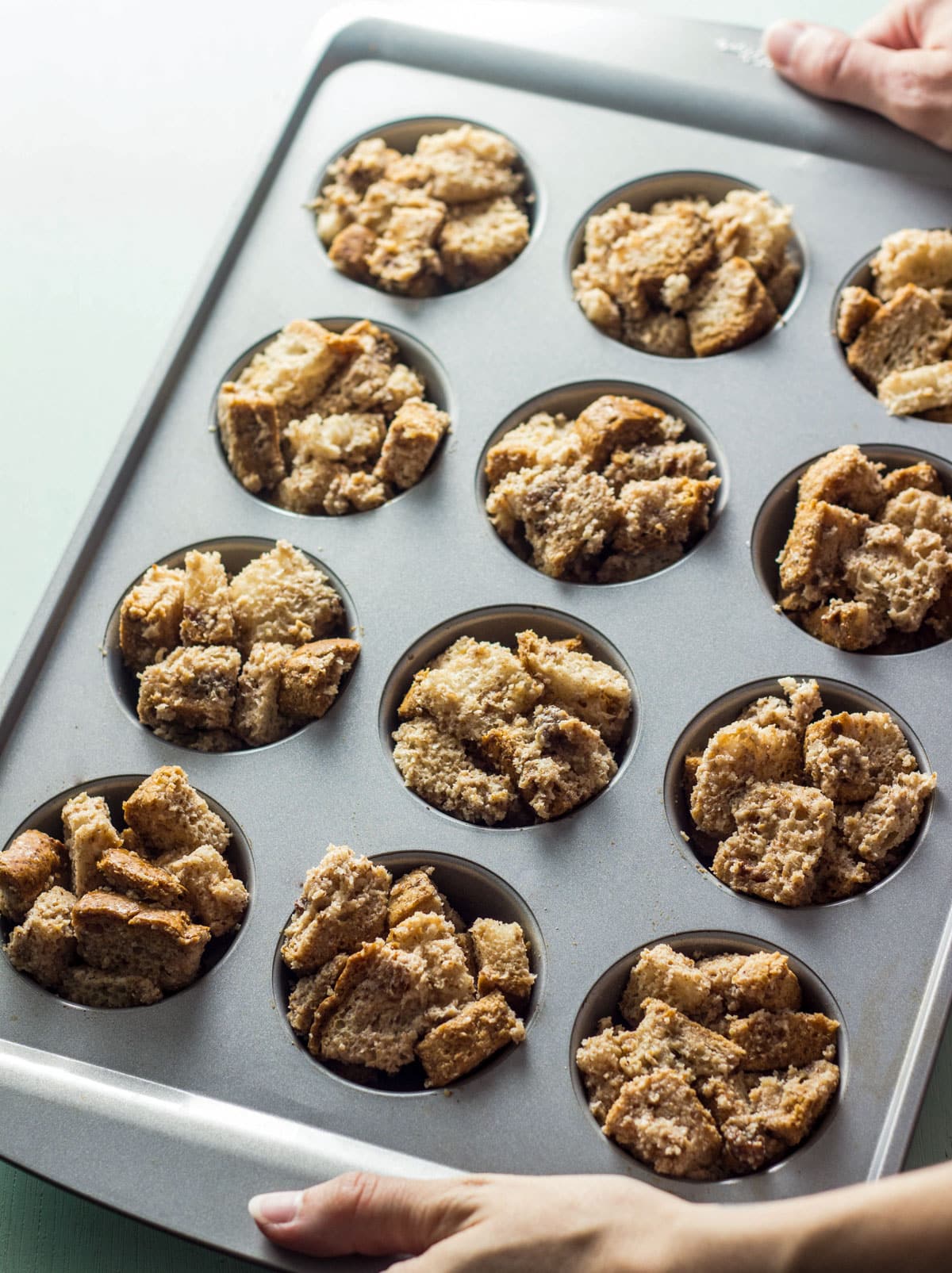 Cinnamon Raisin French Toast Cups in muffin pan before baking.