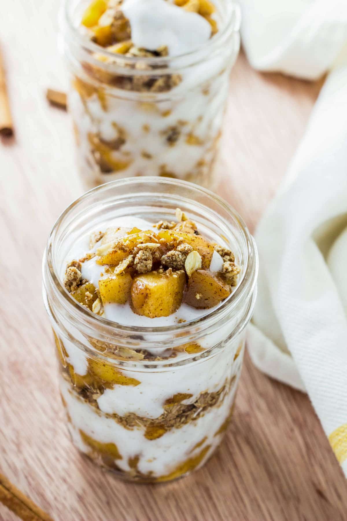 Close up of a small jar of Vegan Sautéed Apple Yogurt Parfait.