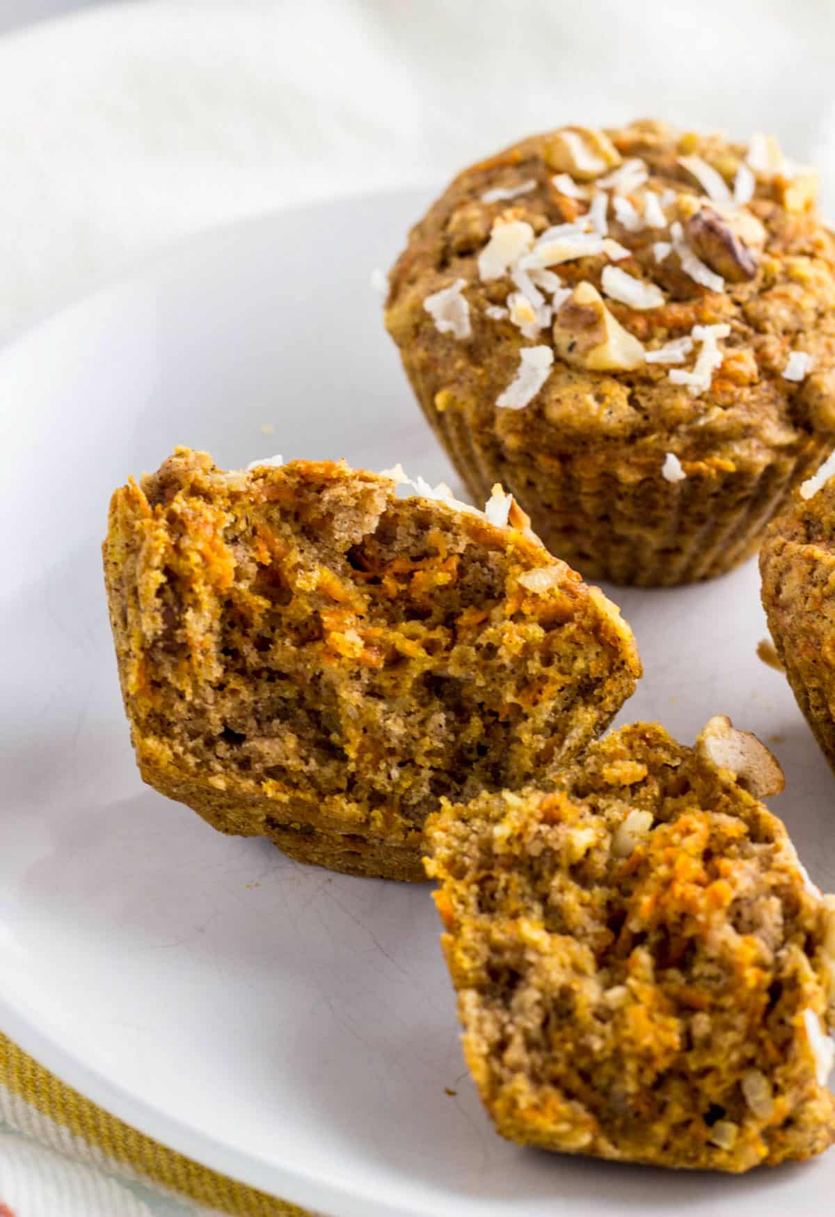 A Whole Wheat Carrot Cake Muffin cut in half showing the interior.