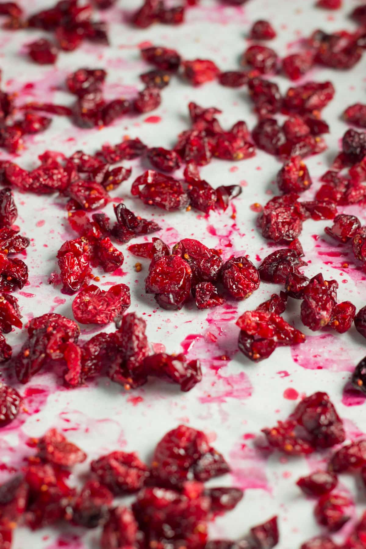 Partially dried cranberries coated in sugar and spread an even layer on a baking sheet.