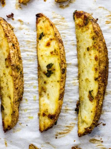 Vegan Cheesy Herb Potato Wedges Feature Image