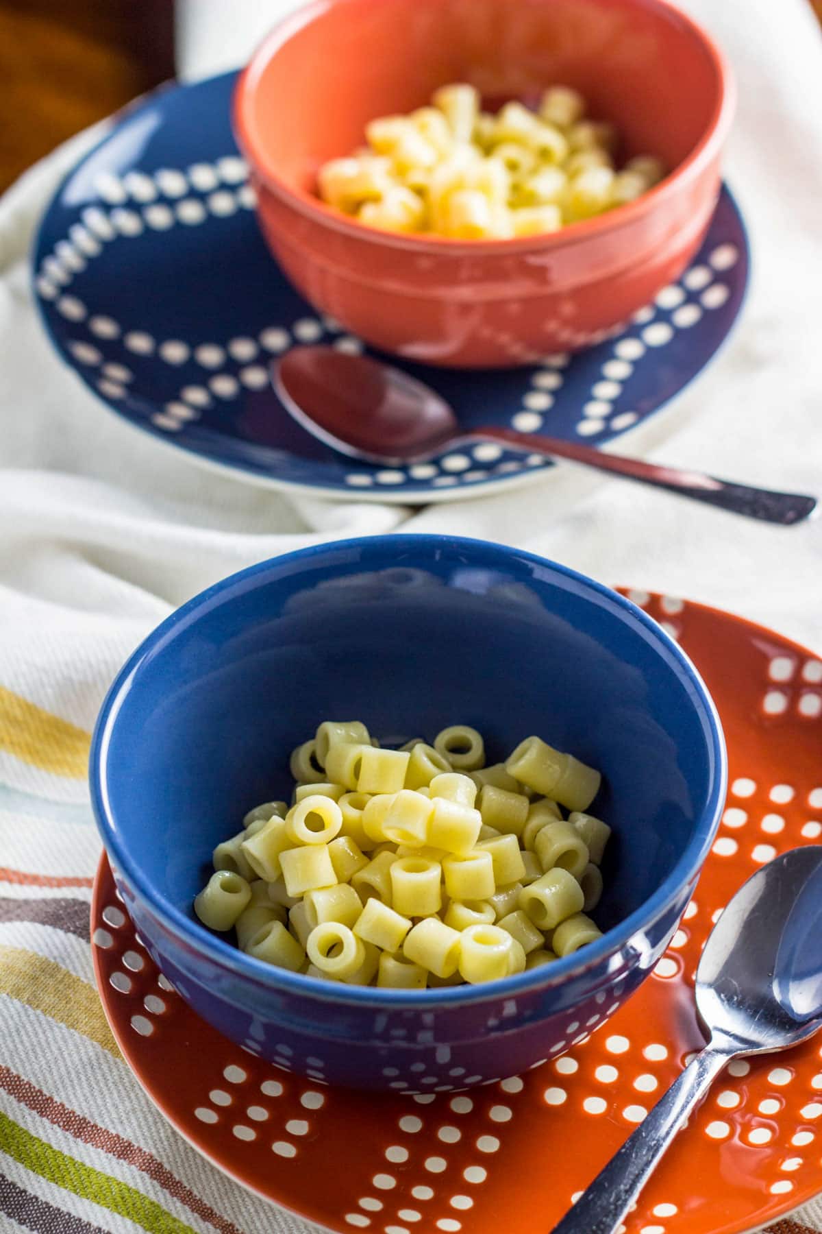 Two small bowls of plain ditalini pasta for Vegan Minestrone Soup.