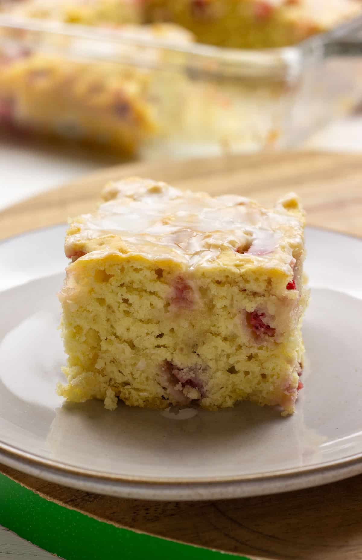 A close up, side view of a Vegan Strawberry Butter Swim Biscuit on a small plate.