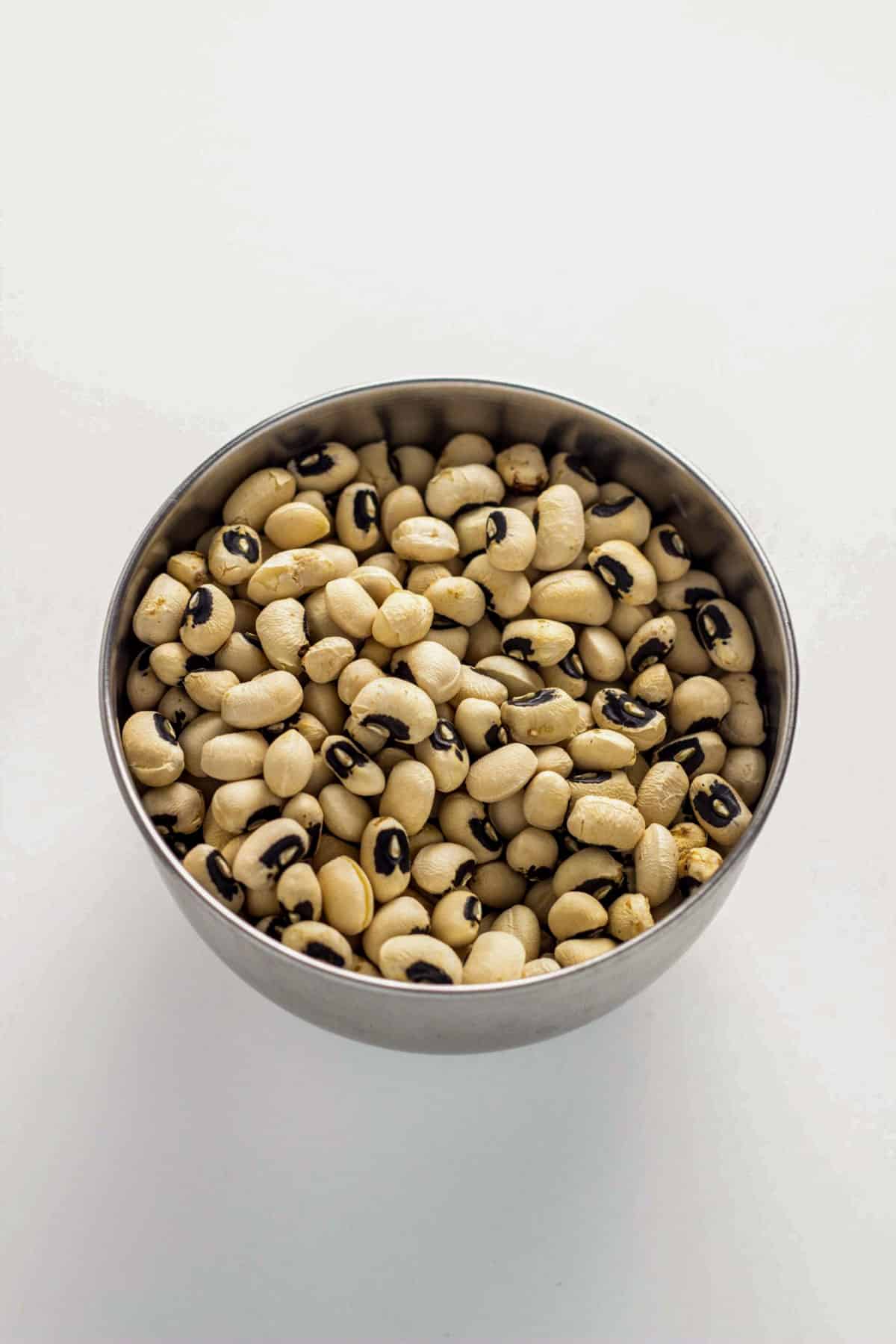 A small bowl of dried black eye peas.