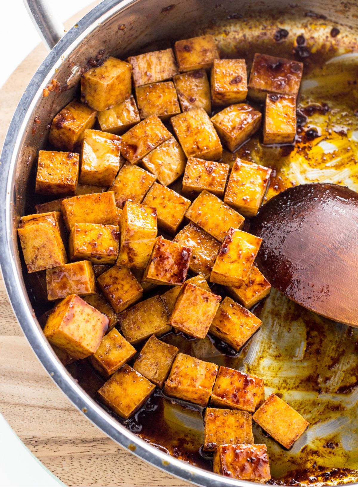 Close up of sauce coated tofu in a skillet.