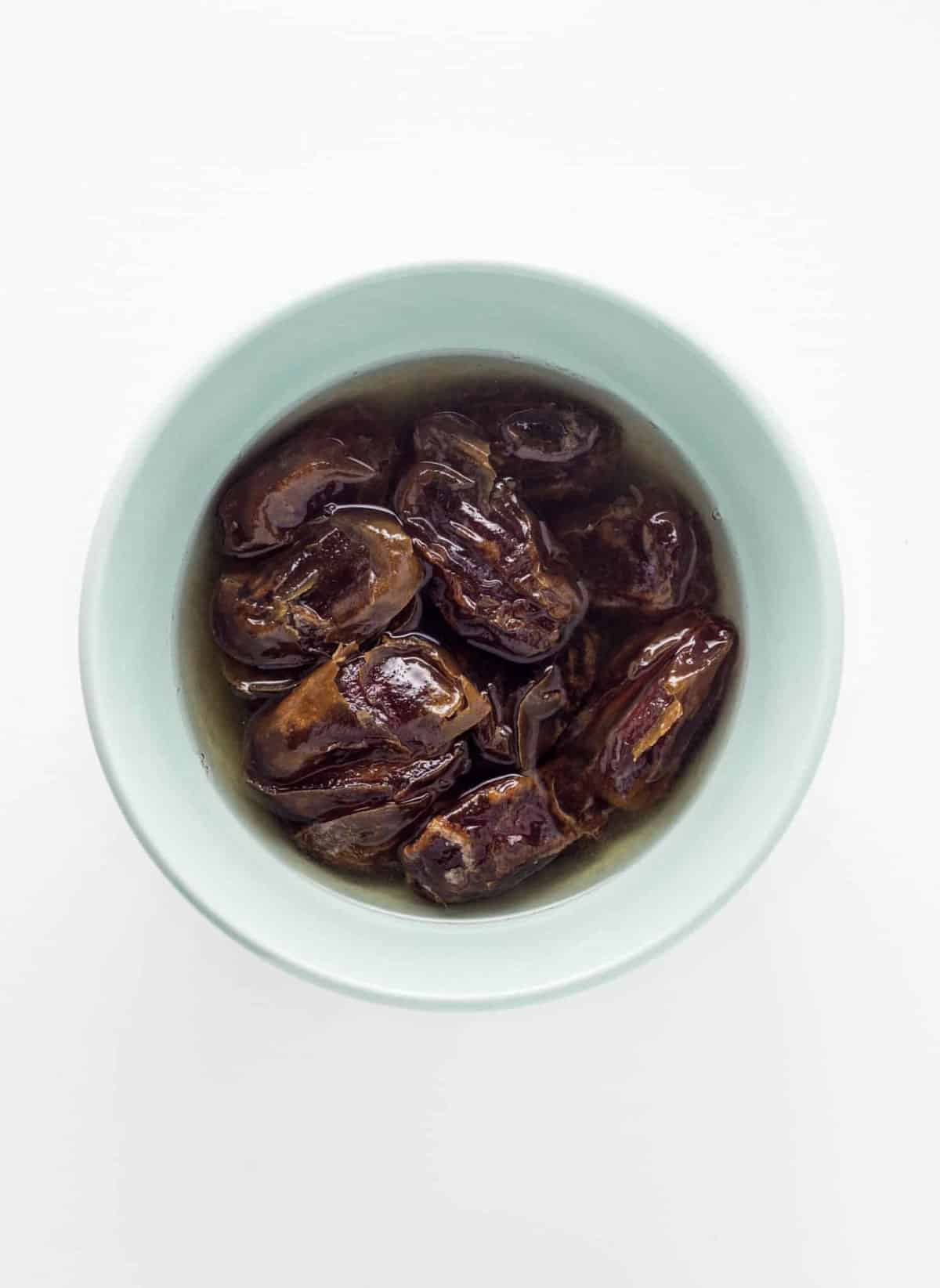 A bowl of dates soaking in water to make date paste.