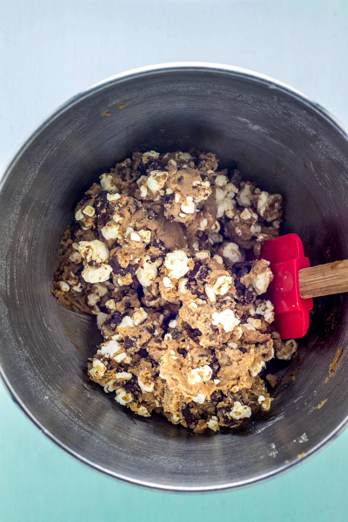 Vegan Movie Snack Cookie dough in a mixing bowl with a rubber spatula.
