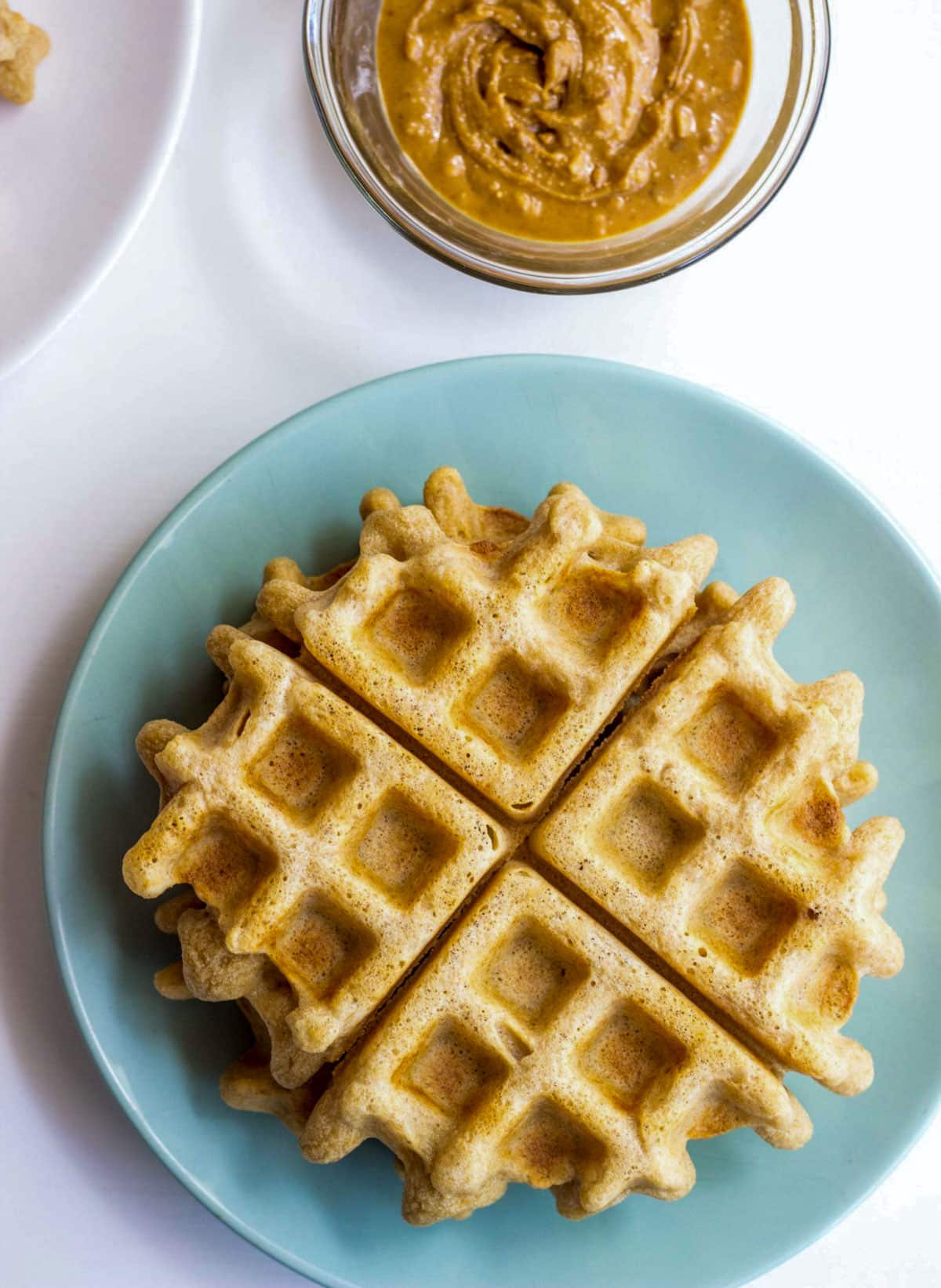 A small stack of Vegan Whole Wheat Waffles on a small plate.