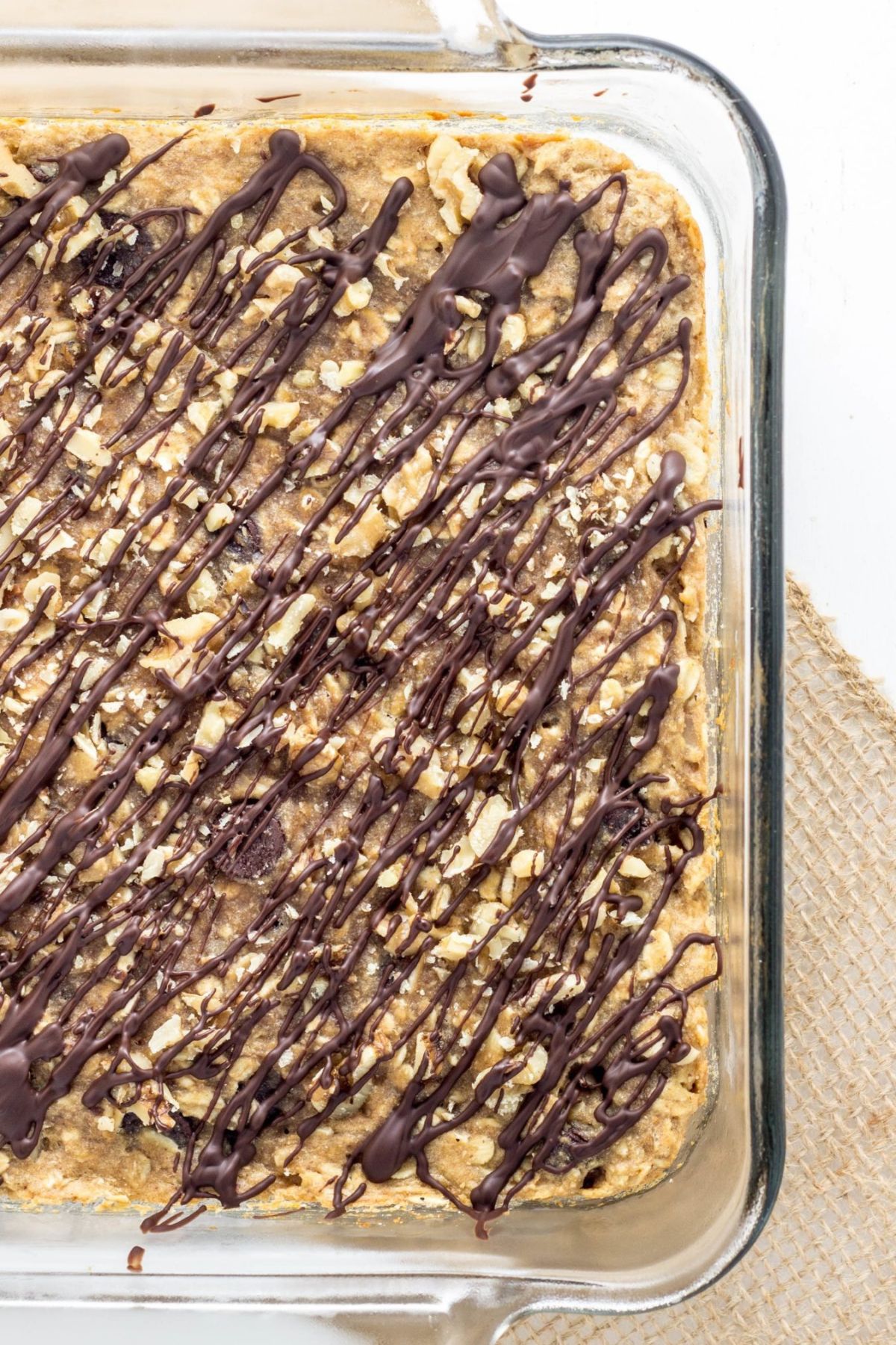 Close up of Banana Nut Chocolate Chip Oatmeal Squares in a glass baking dish.