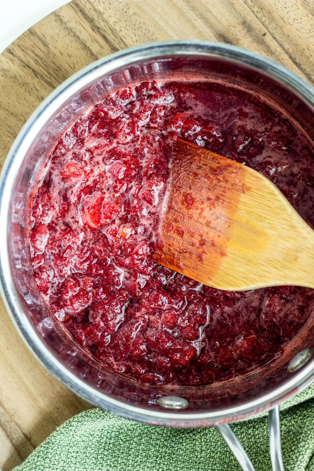 Overhead view of a pot of strawberry sauce. The sauce will be swirled into coconut ice cream.