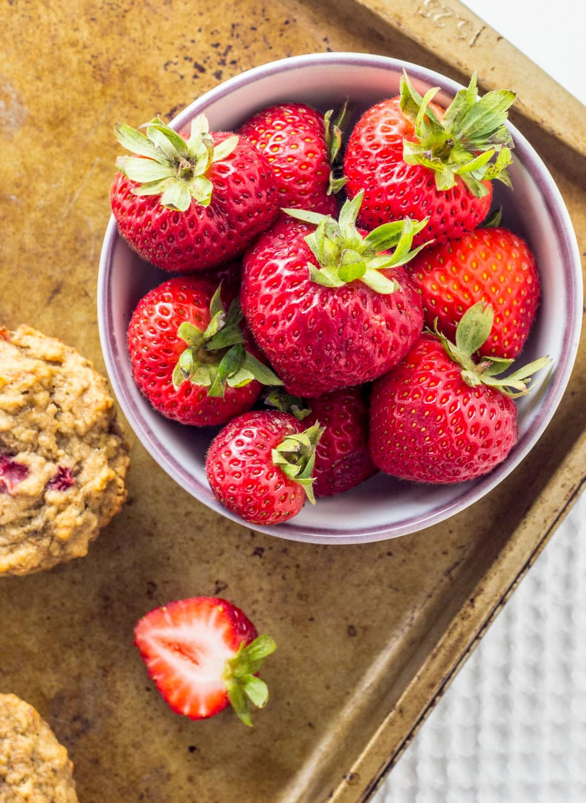 Close up view of a bowl of fresh strawberries.