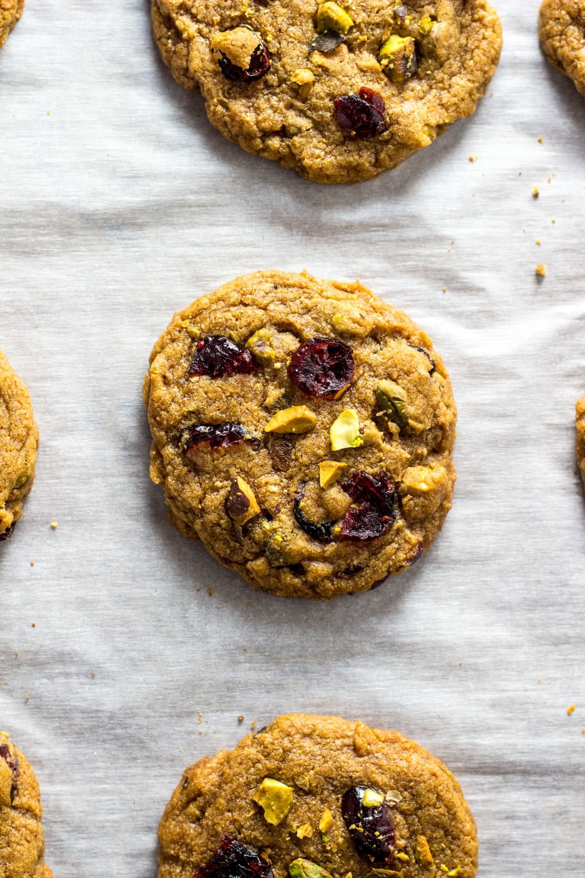 Close up of Vegan Cranberry Pistachio Cookies on on a sheet pan after baking.