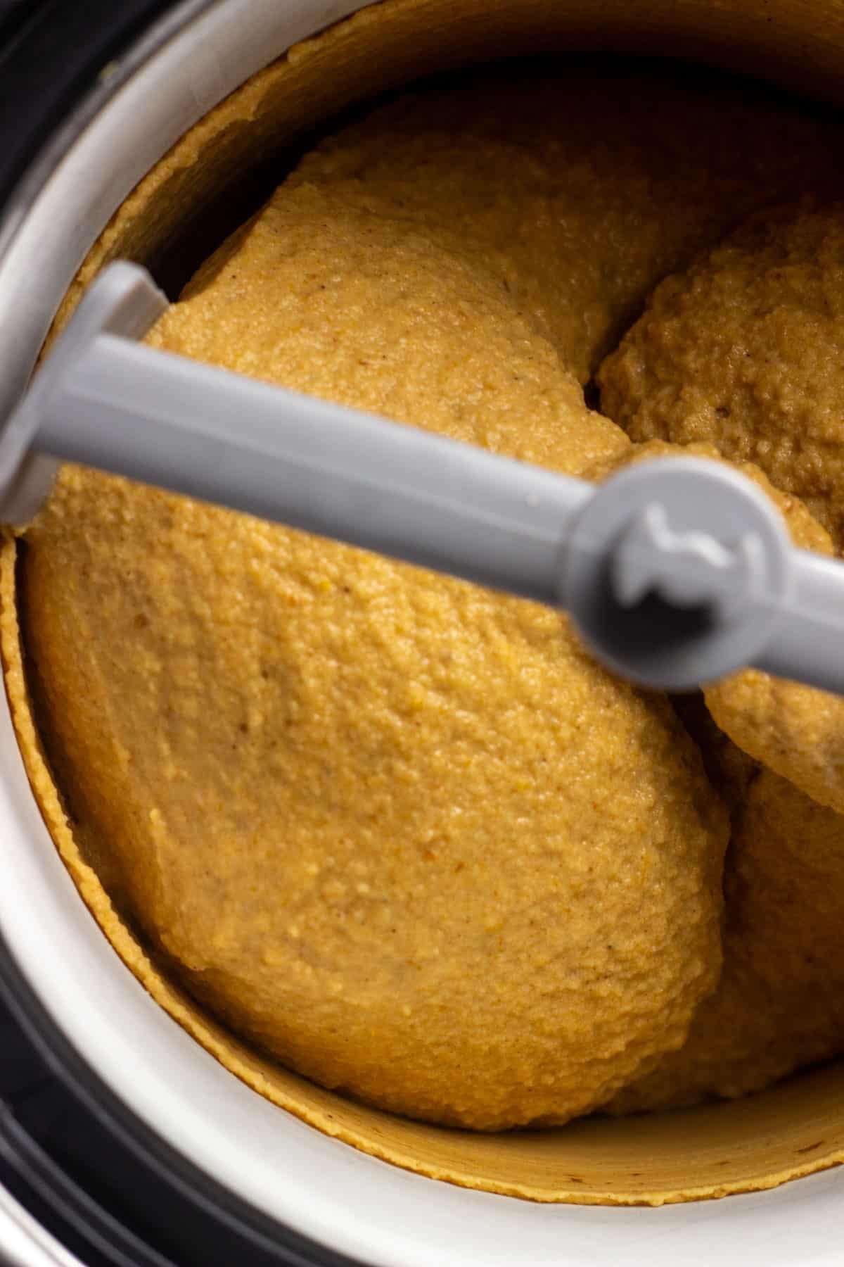 Close up of Vegan Pumpkin Ice Cream churning in an ice cream maker.